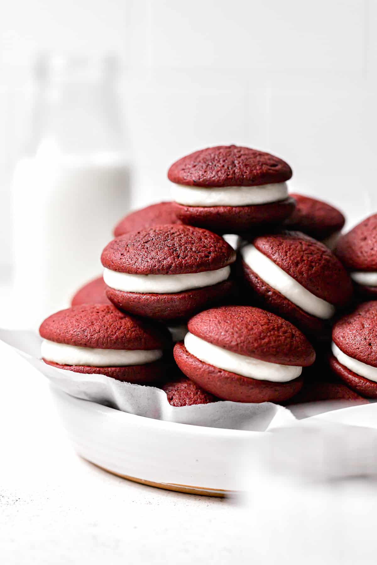 mini whoopie pies stacked in white bowl.