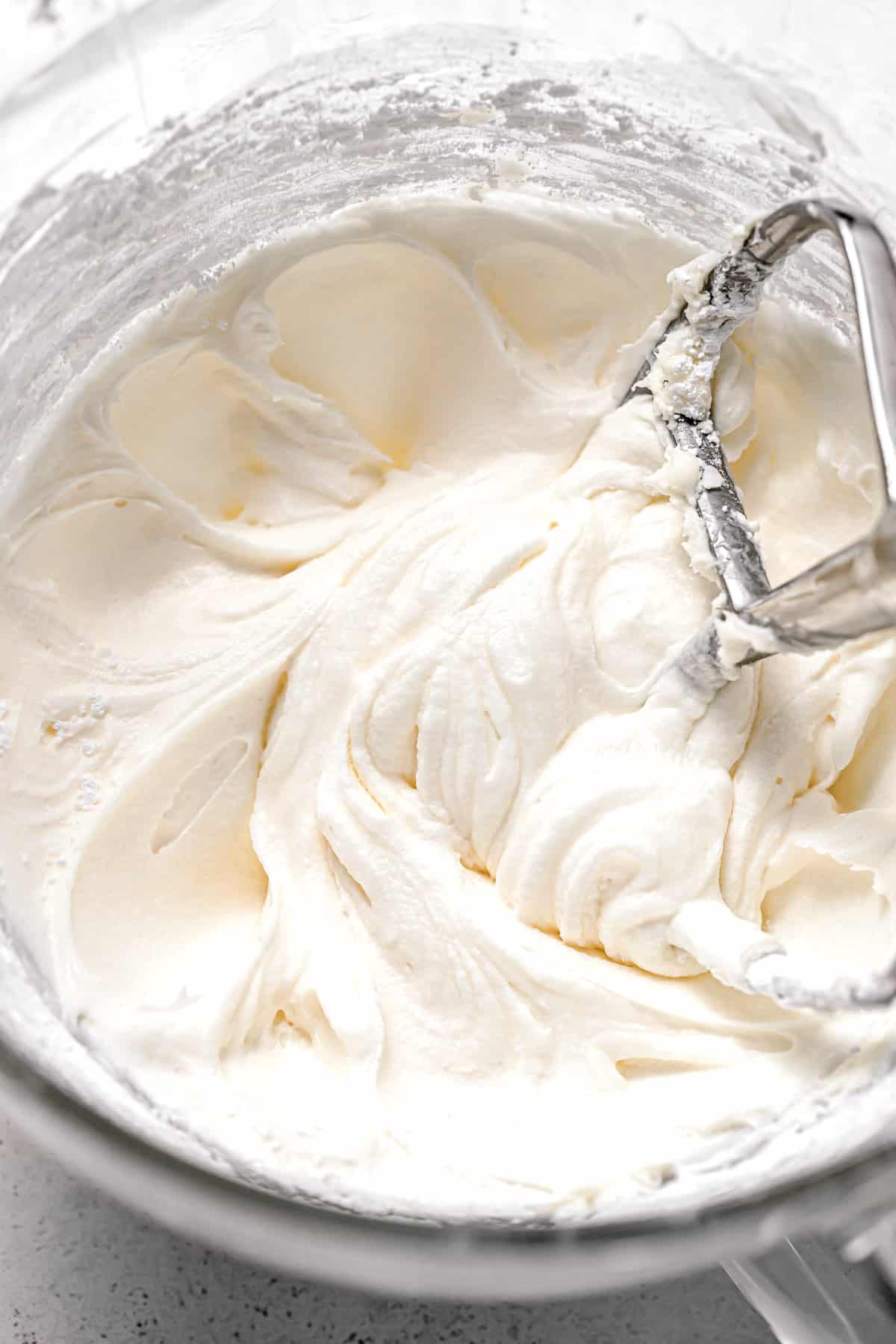 cream cheese frosting in glass bowl