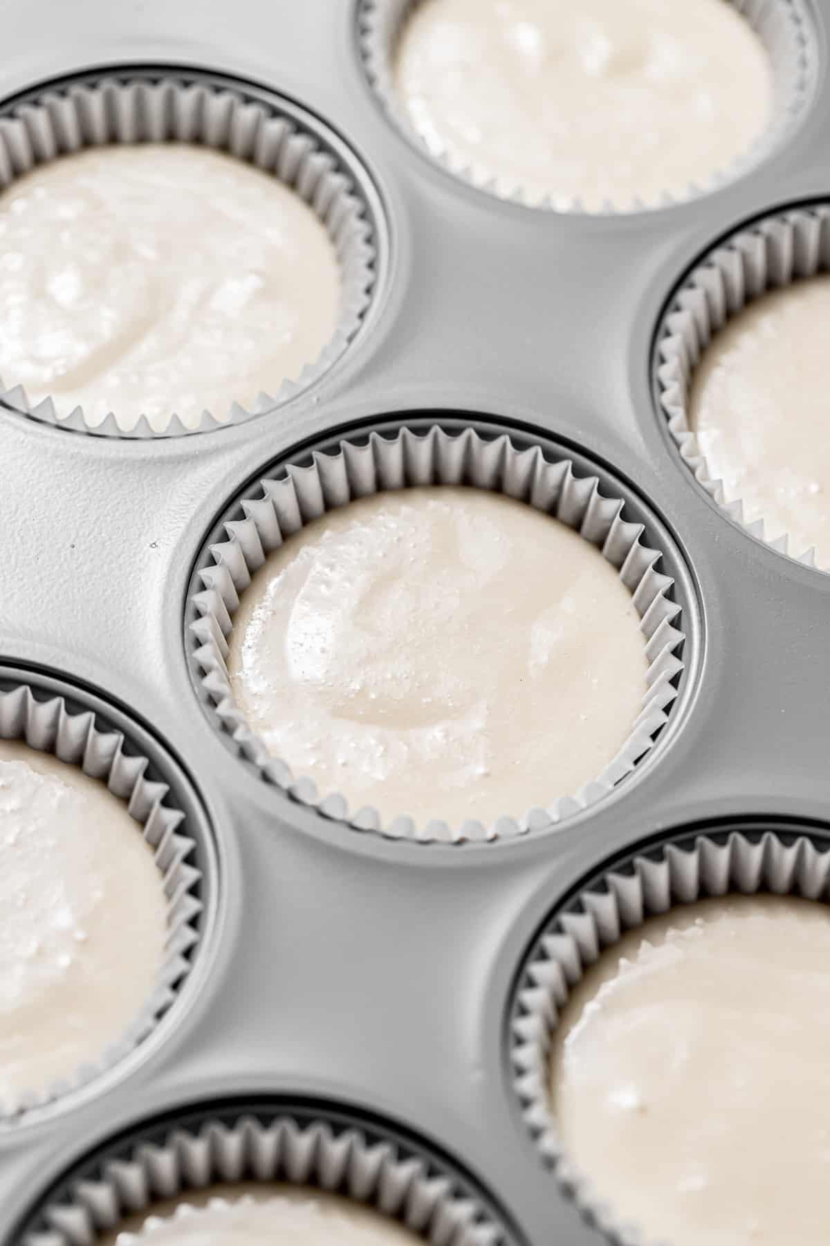coconut cupcake batter in muffin pan. 