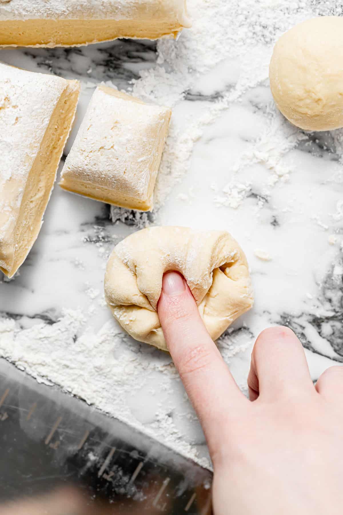 dough being shaped into balls.