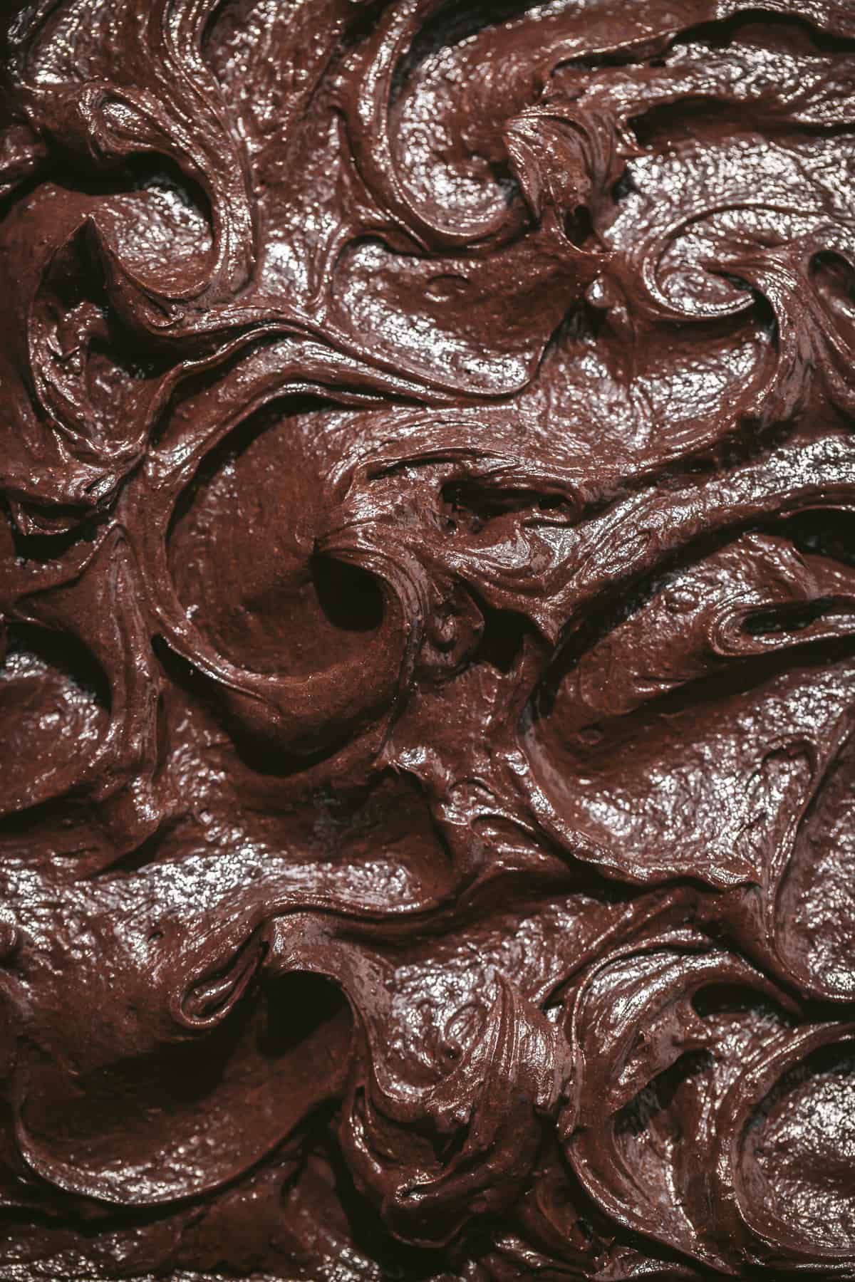 chocolate frosting swirled on cake. 