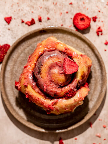 roasted strawberry cinnamon roll on plate.