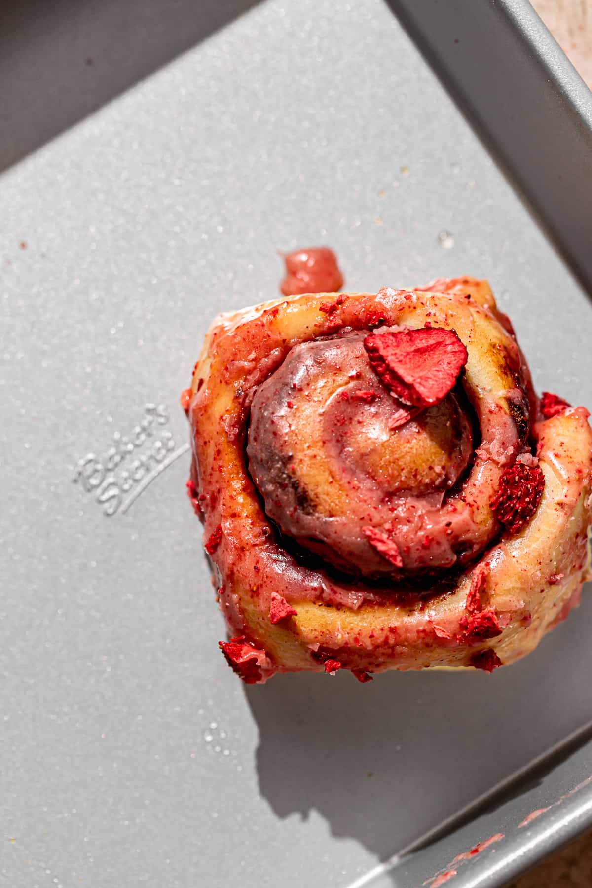 strawberry cinnamon roll in square pan.