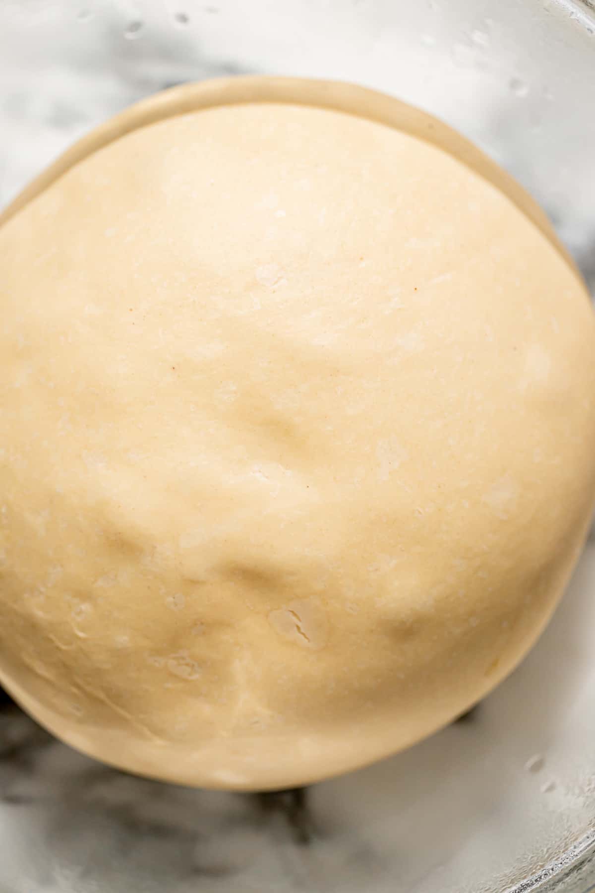 proofed brioche dough in bowl.