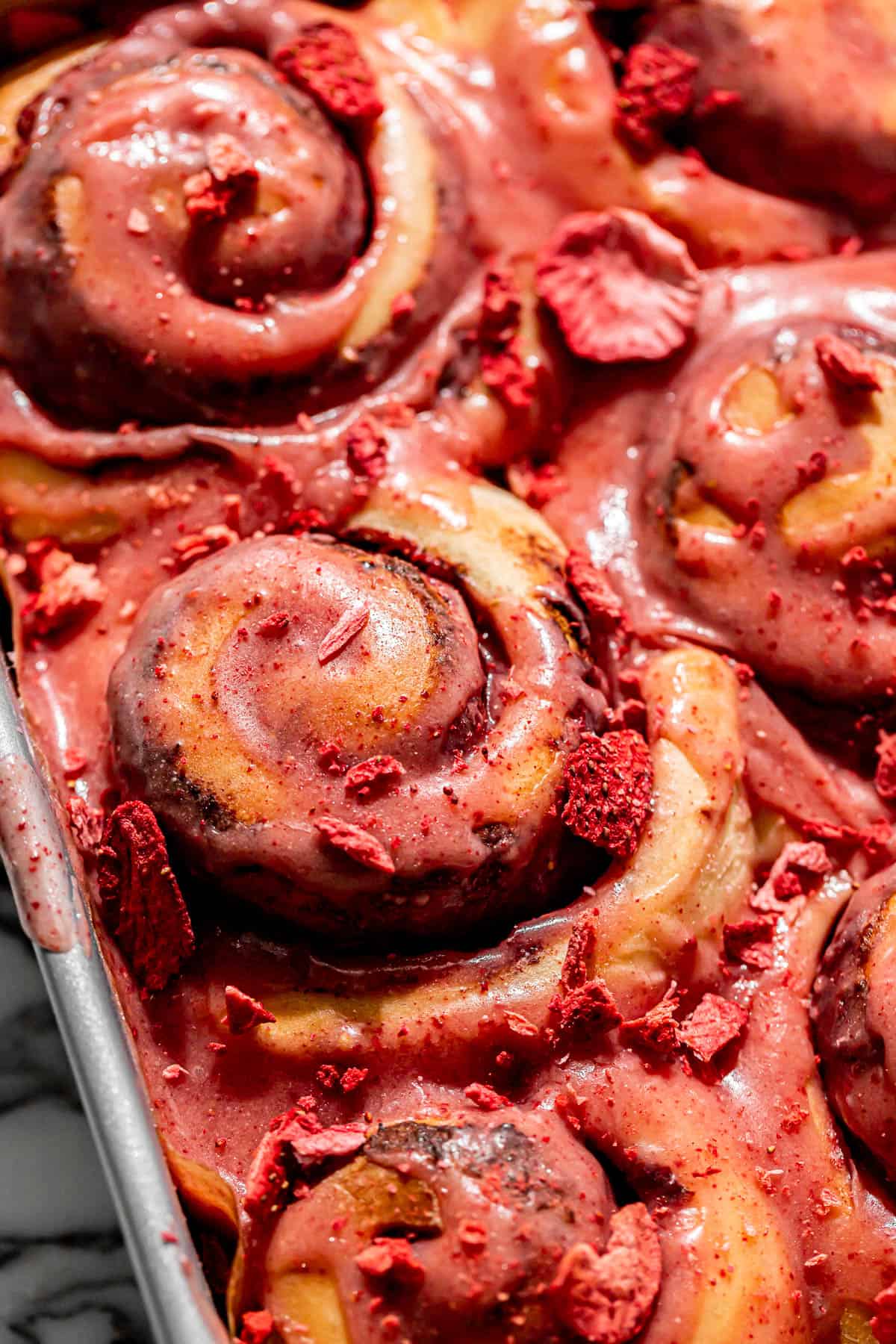 strawberry cinnamon rolls in square pan. 