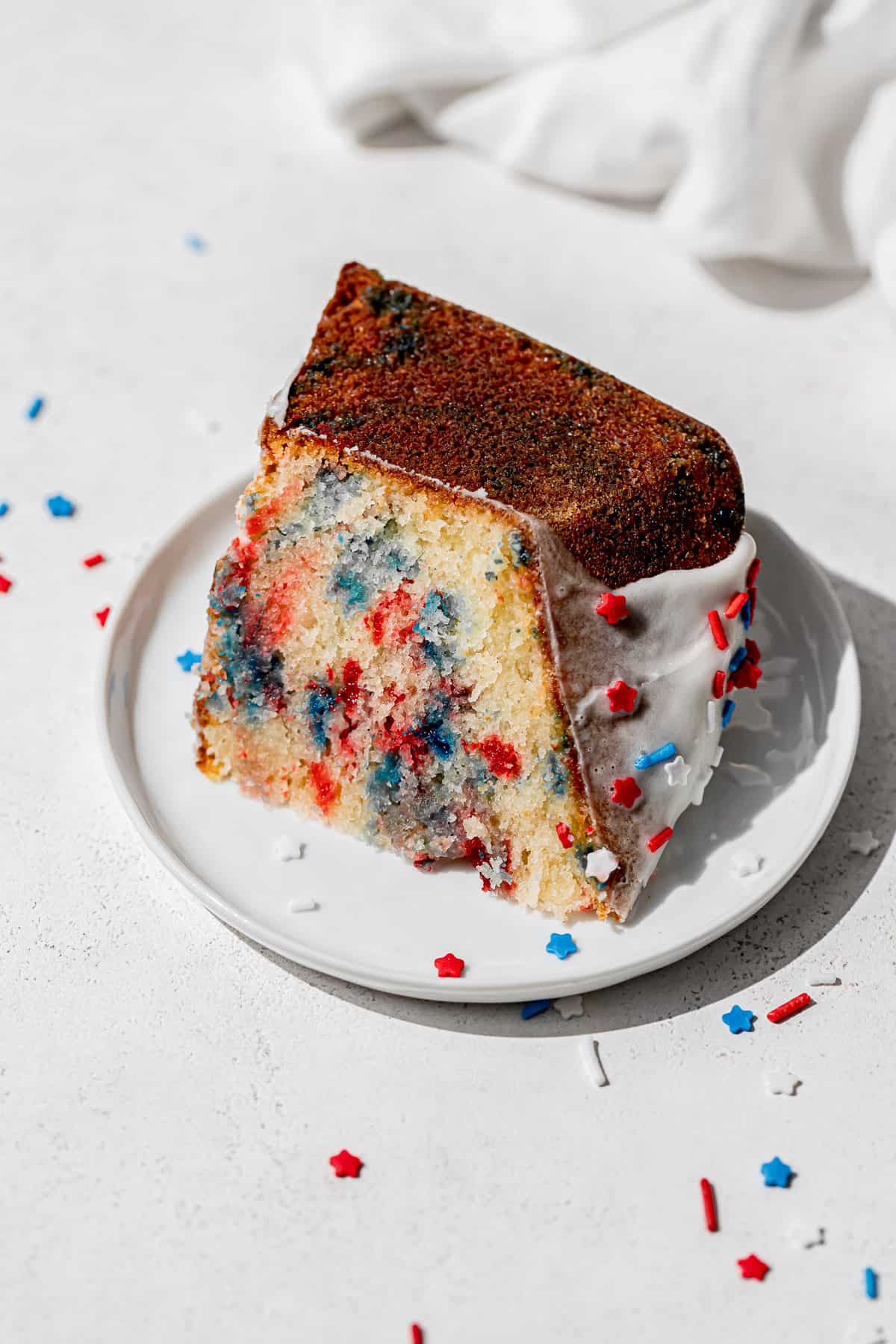 one slice of 4th of July cake on small white plate.