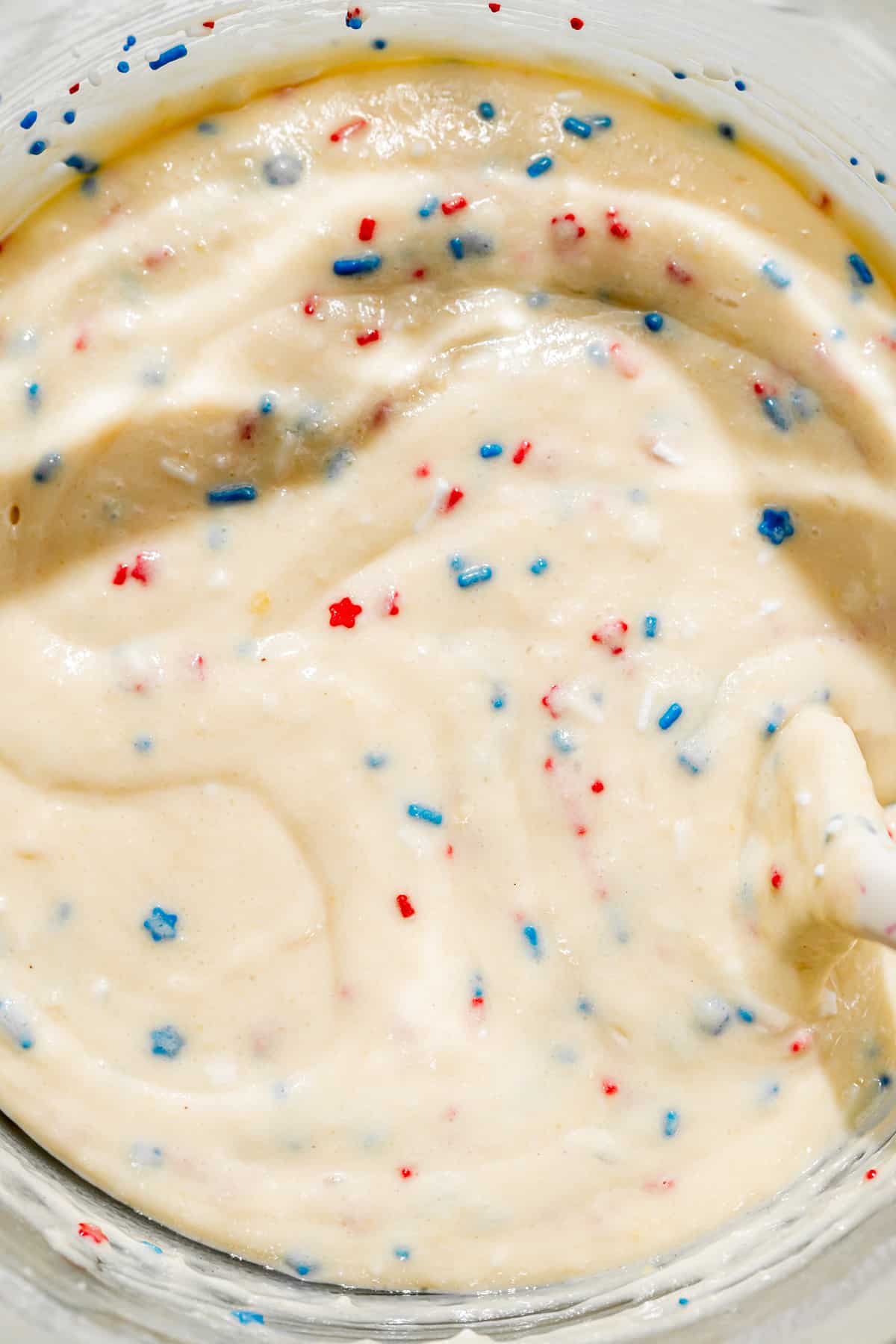 red, white, and blue sprinkles folded into cake batter.
