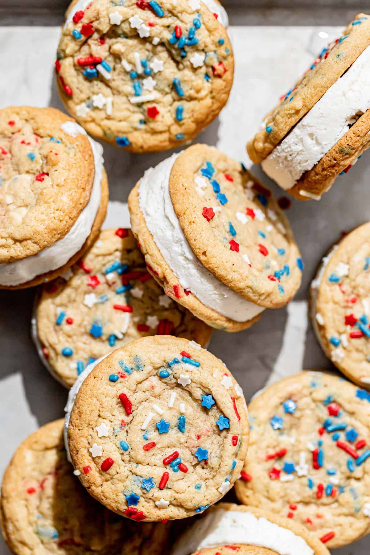 4th of July cookies sandwiched with ice cream on baking sheet.