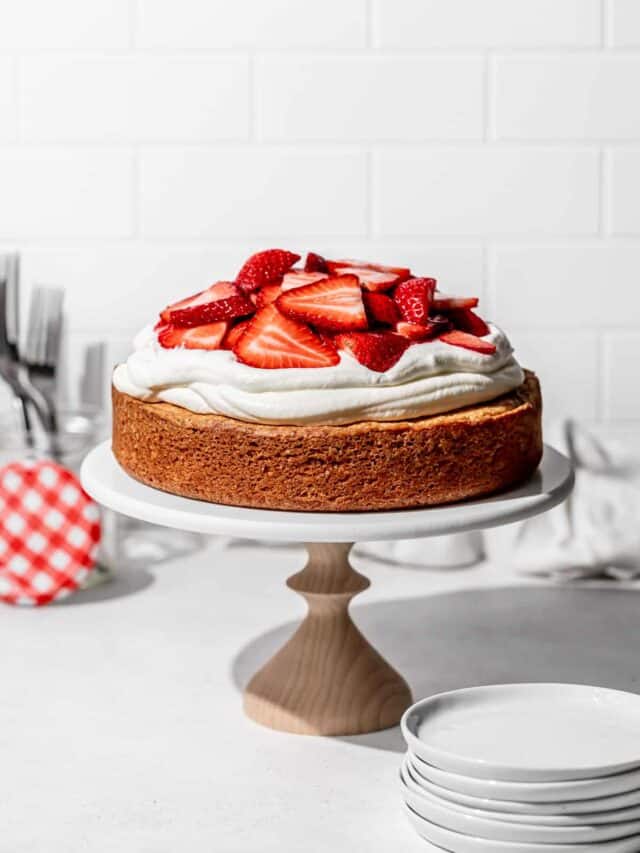 gluten free strawberry shortcake cake on cake stand.