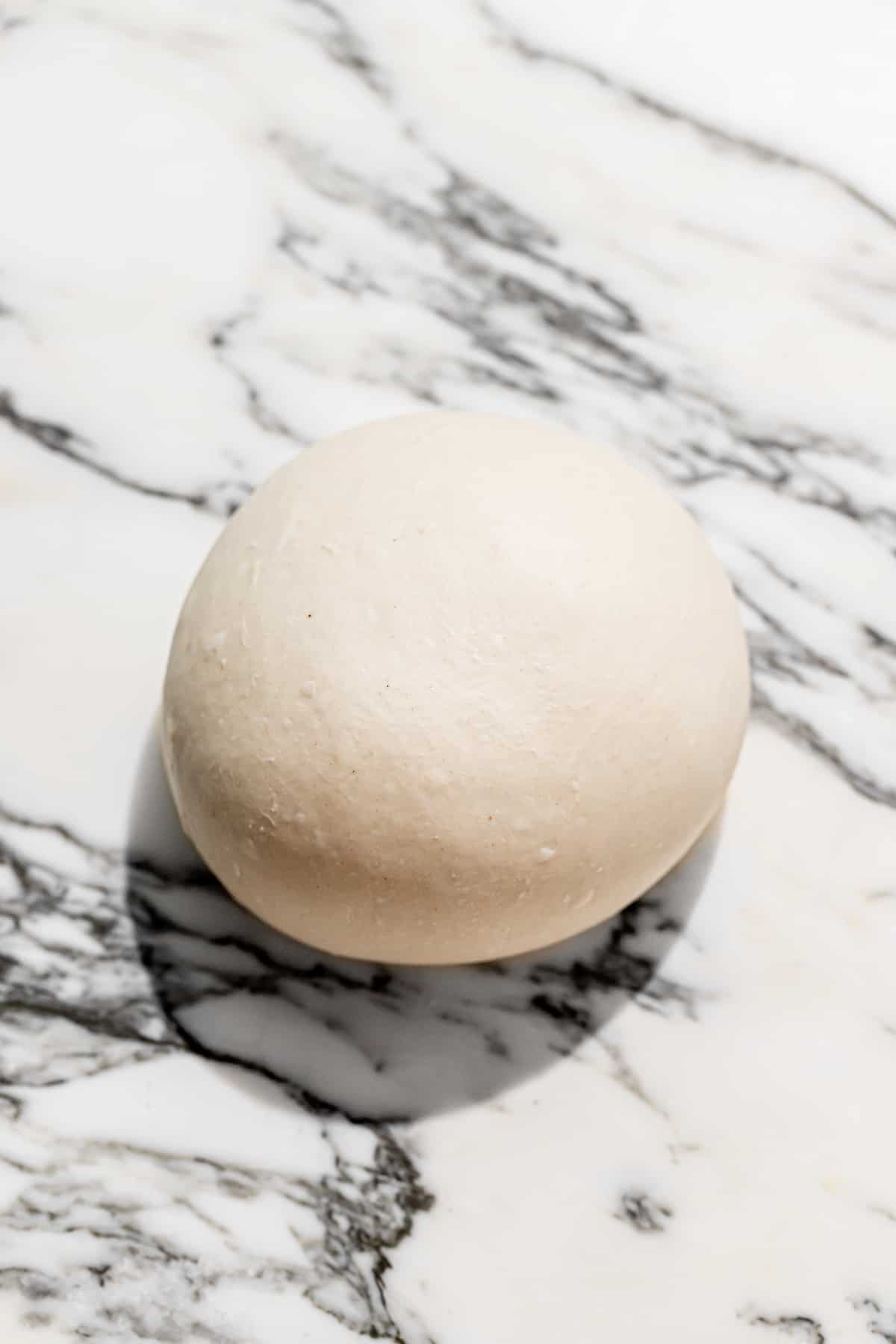 pizza dough ball on marble. 