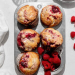 raspberry muffins in small muffin pan.