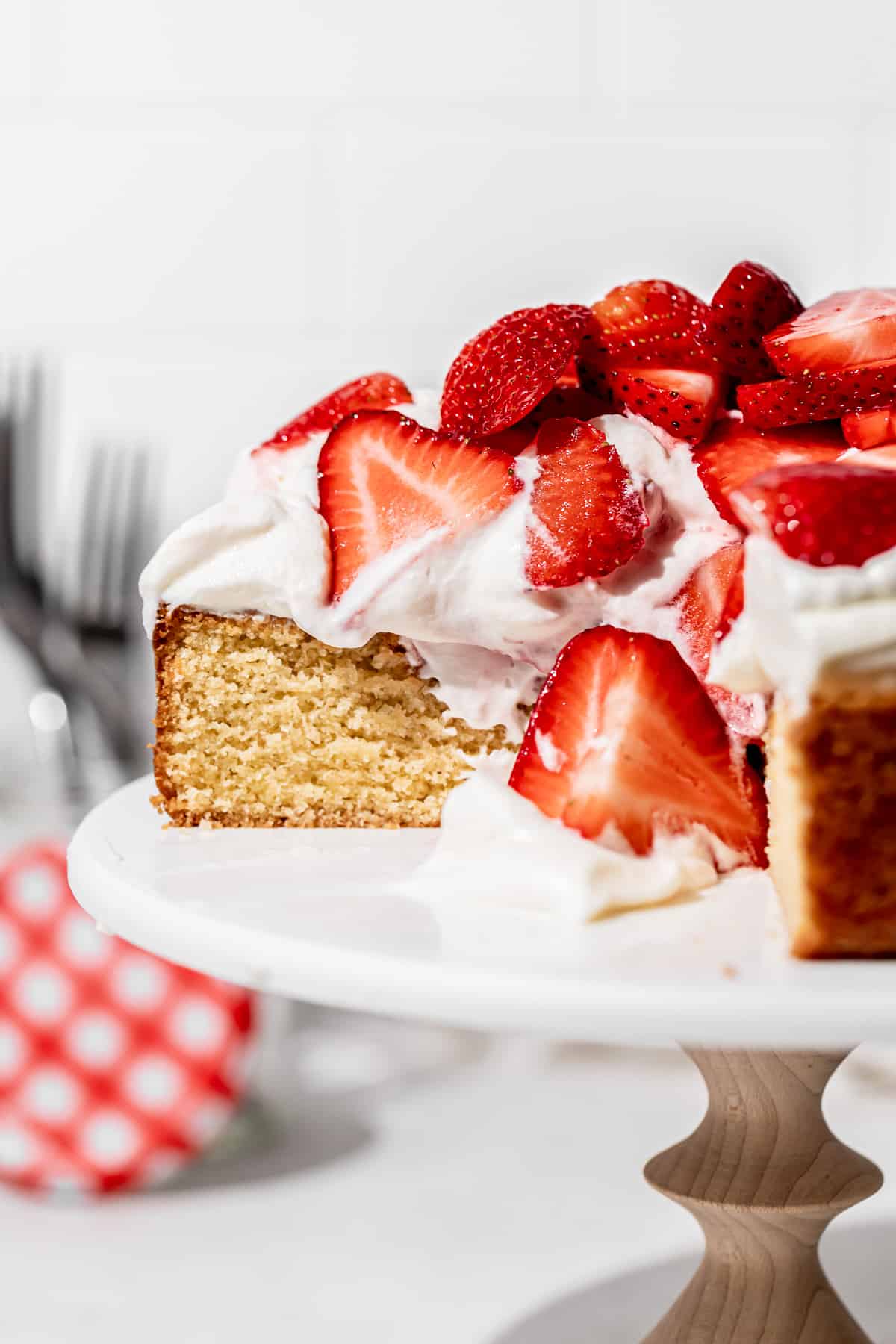 gluten free strawberry shortcake cake on cake stand stand cut to show inside texture.