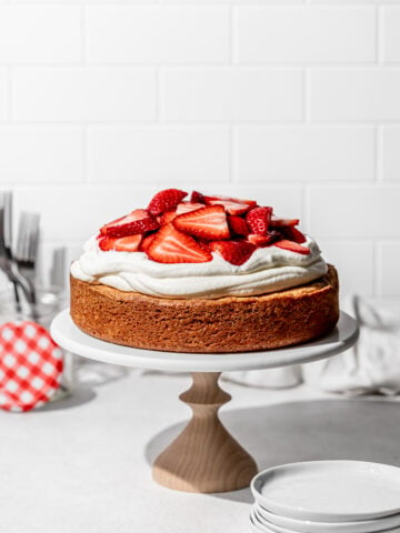 gluten free strawberry shortcake cake on cake stand.