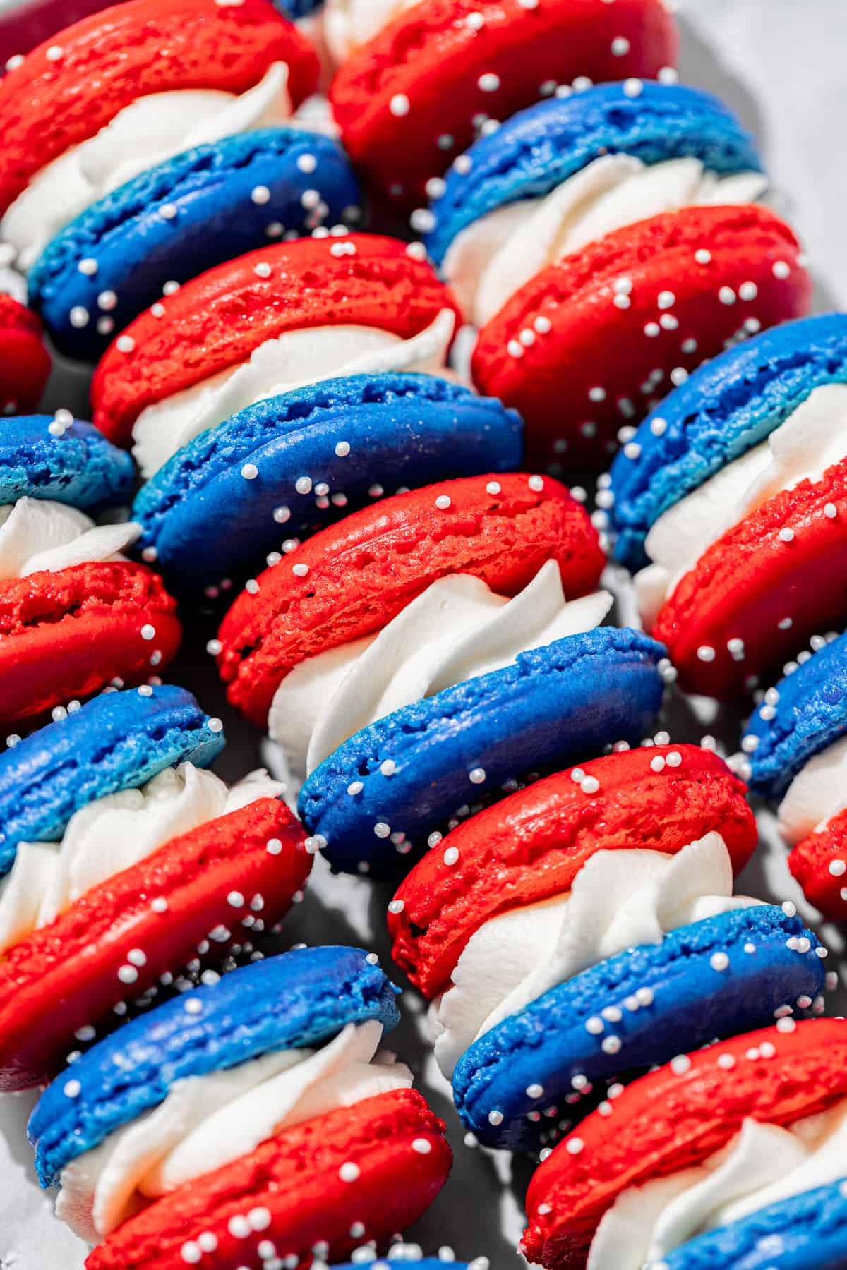 4th of July macarons lined up on baking sheet. 