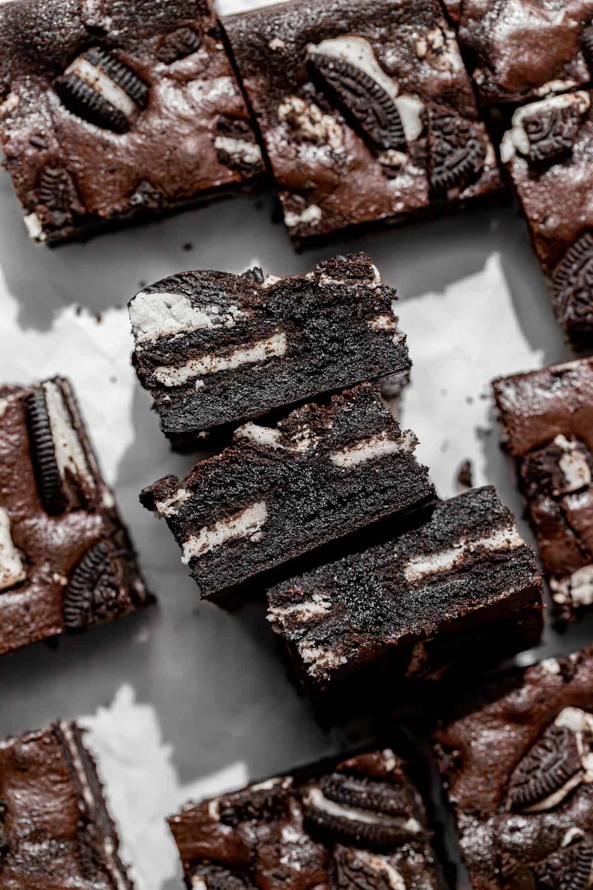 oreo brownies lined up on parchment paper.