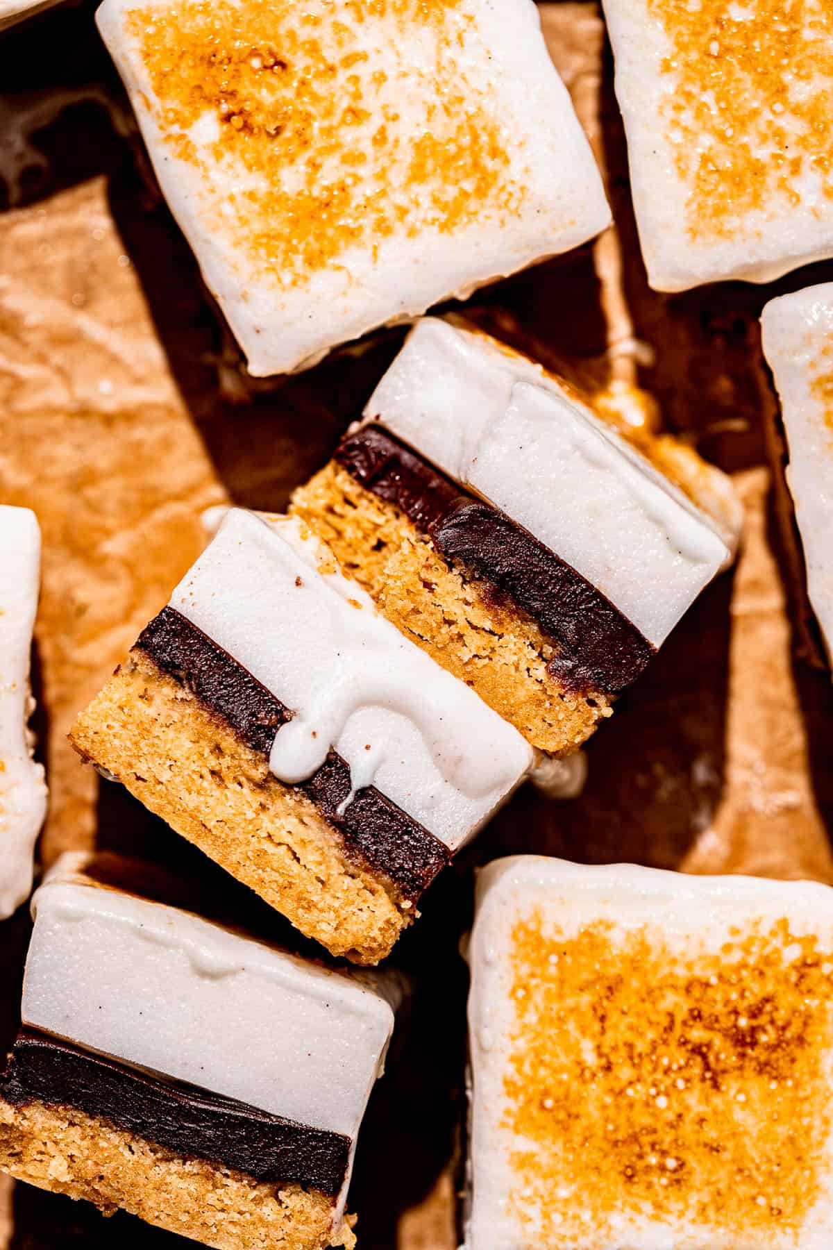 s'mores bars lined up on parchment paper. 