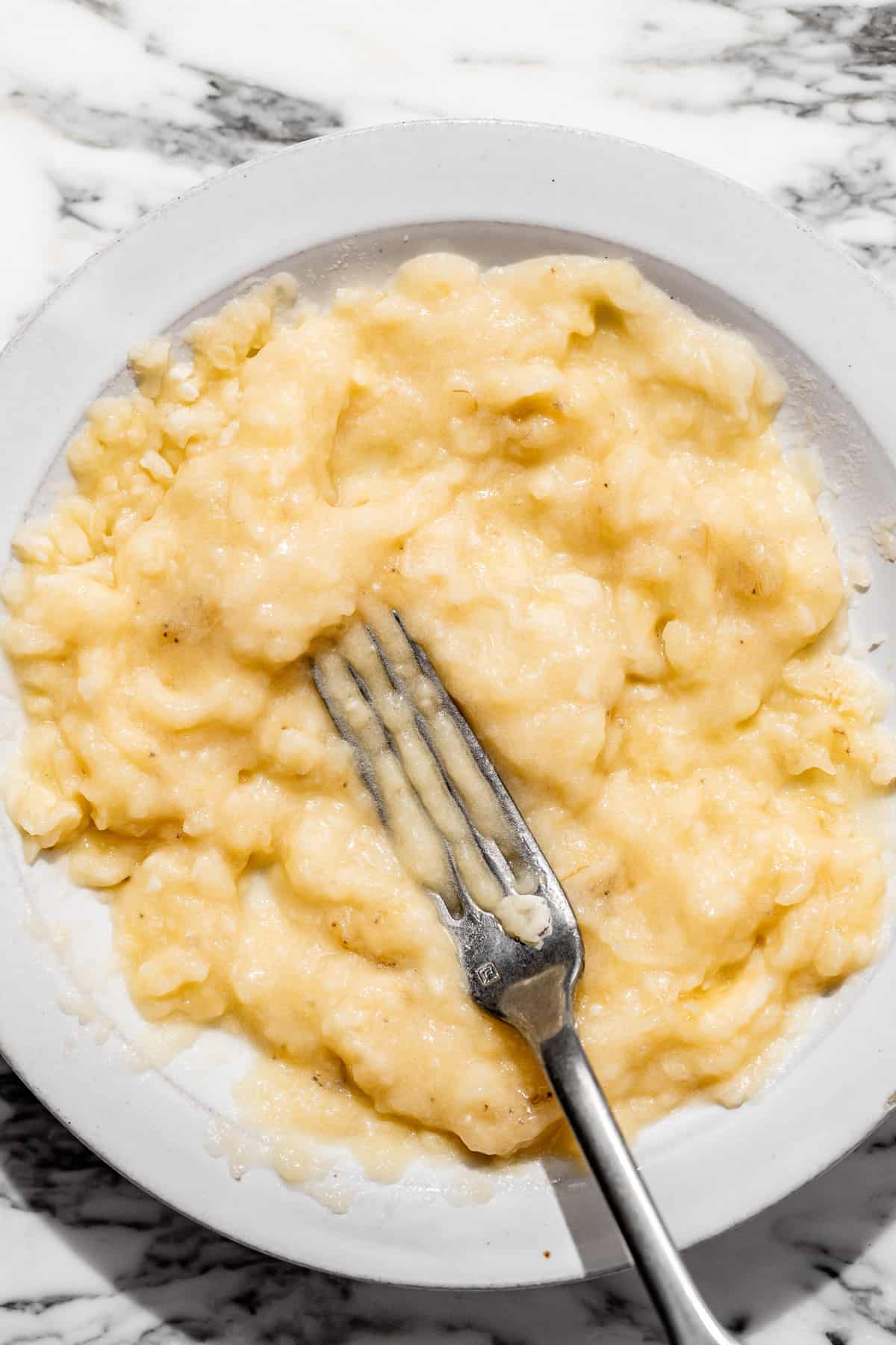 mashed bananas on a white plate.