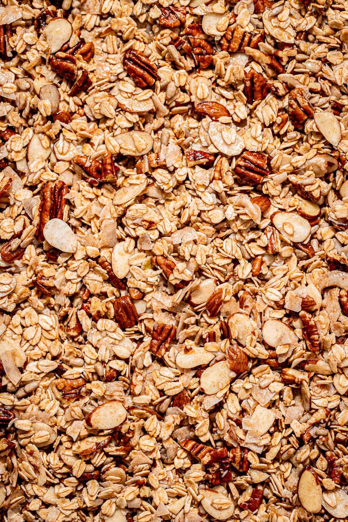 maple nut granola ingredients on a baking tray.