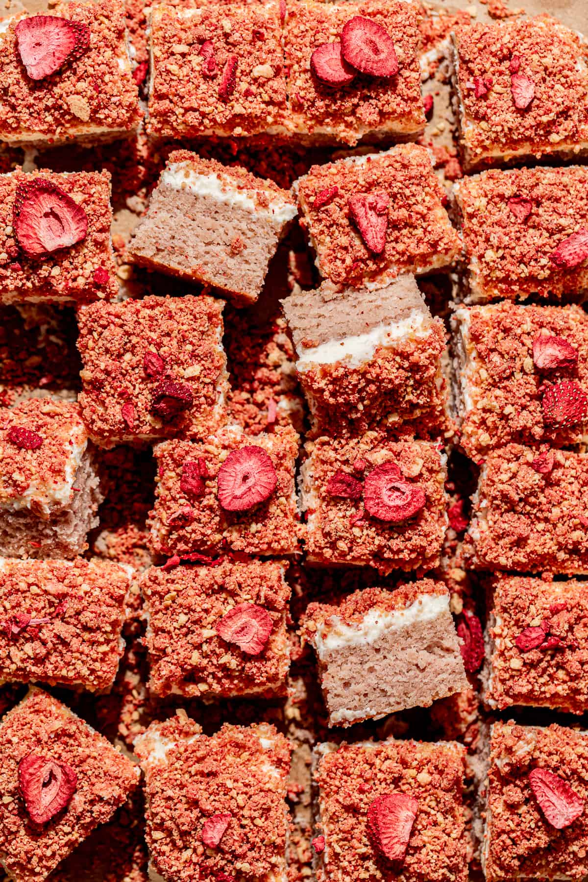overhead view of strawberry crunch cake cut into squares.