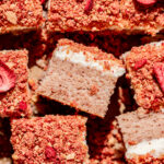 strawberry crunch cake cut into squares.