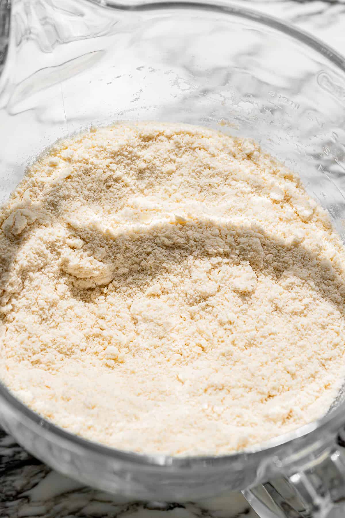 butter mixed into dry ingredients in a glass bowl. 