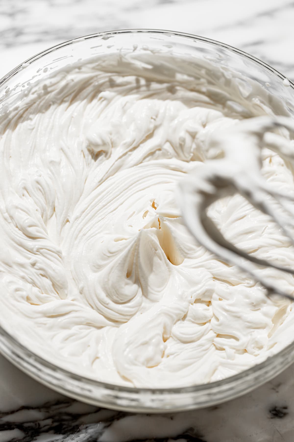 mascarpone frosting whipped in a glass bowl.