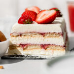 strawberry icebox cake with fresh strawberries on top.