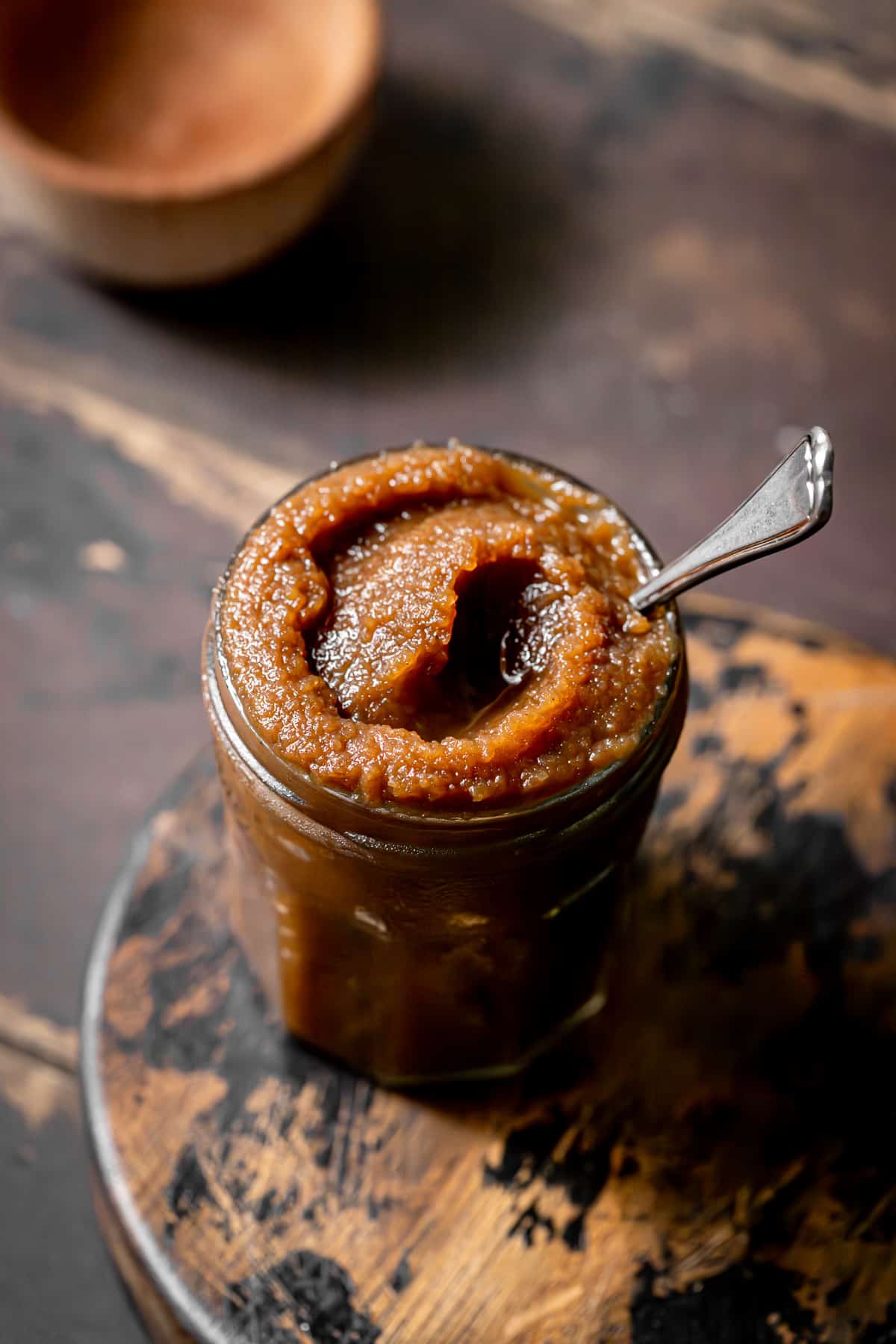 apple butter in jar with spoon.
