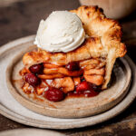 slice of apple cranberry pie on plate.