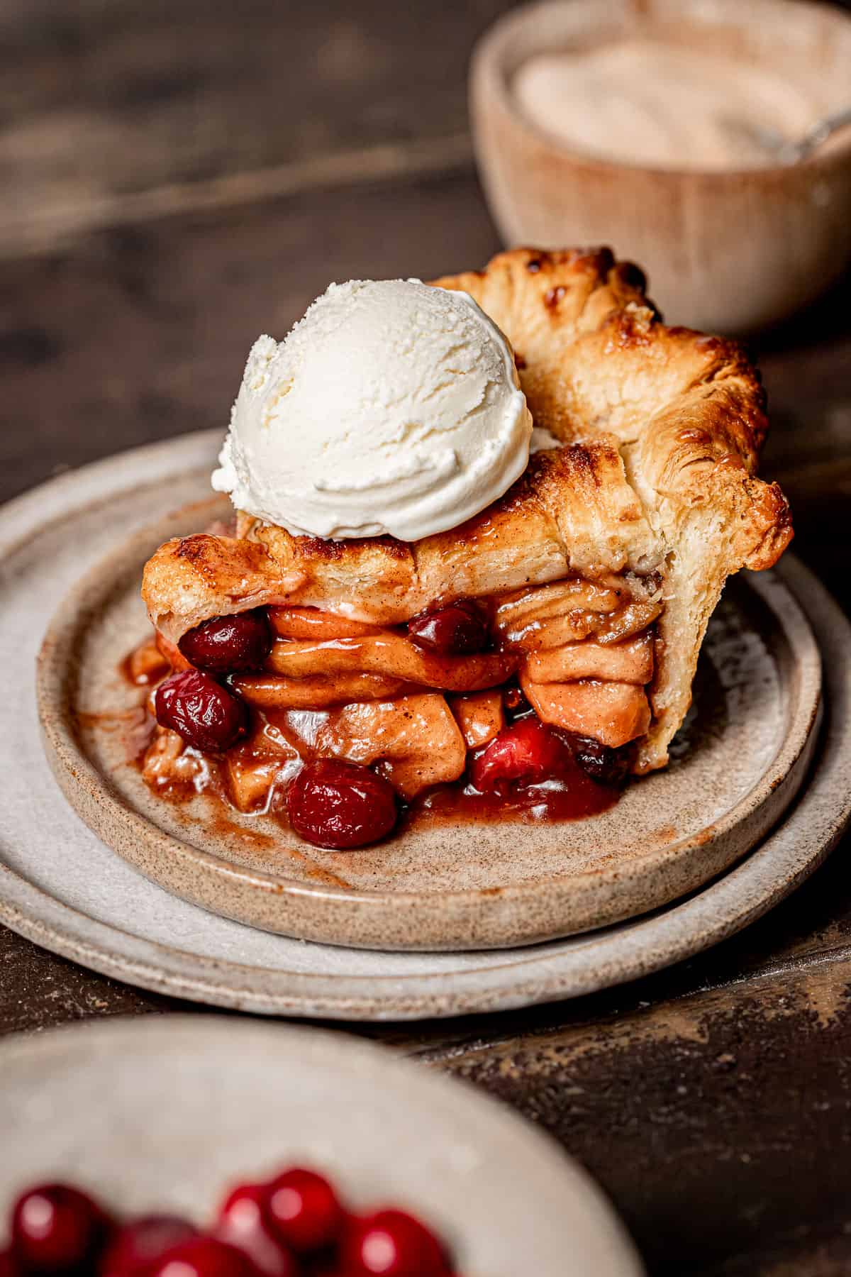 slice of apple cranberry pie on plate.