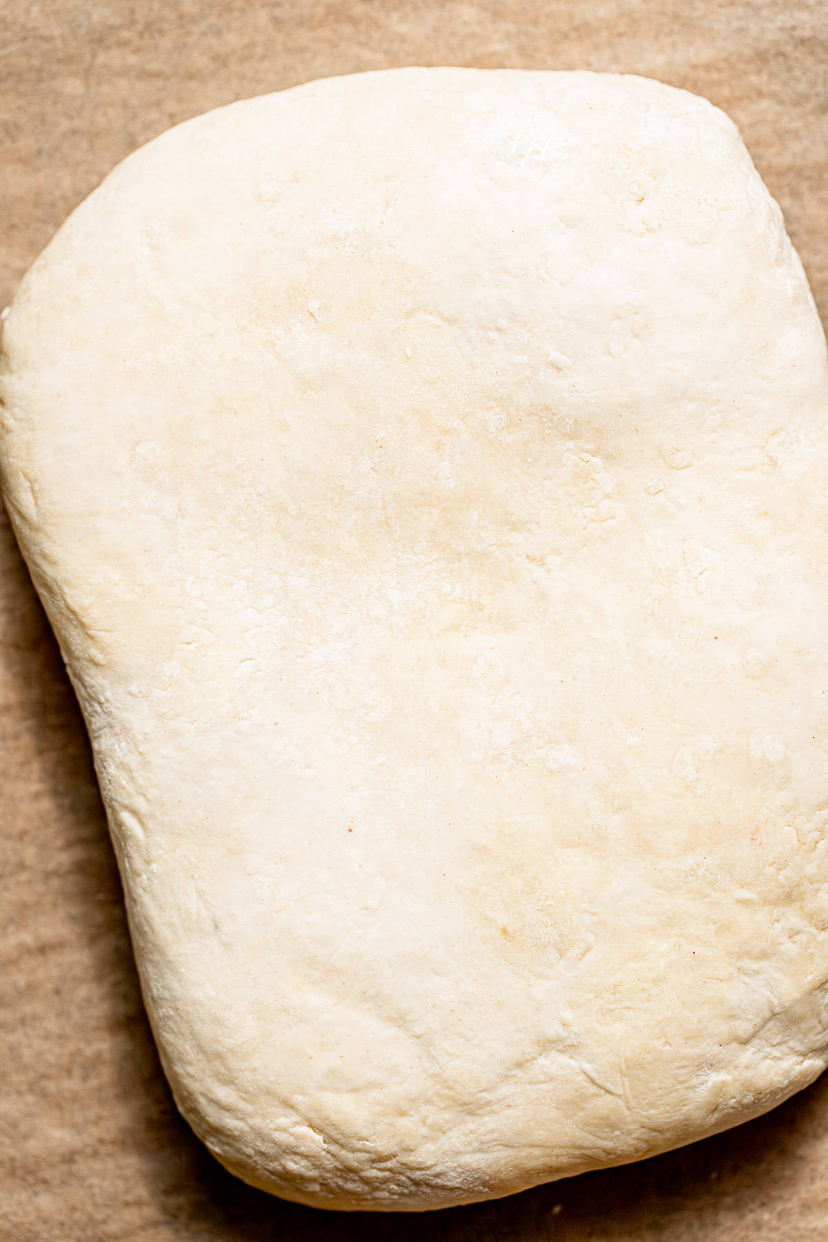 rolled and folded pie crust on parchment paper.