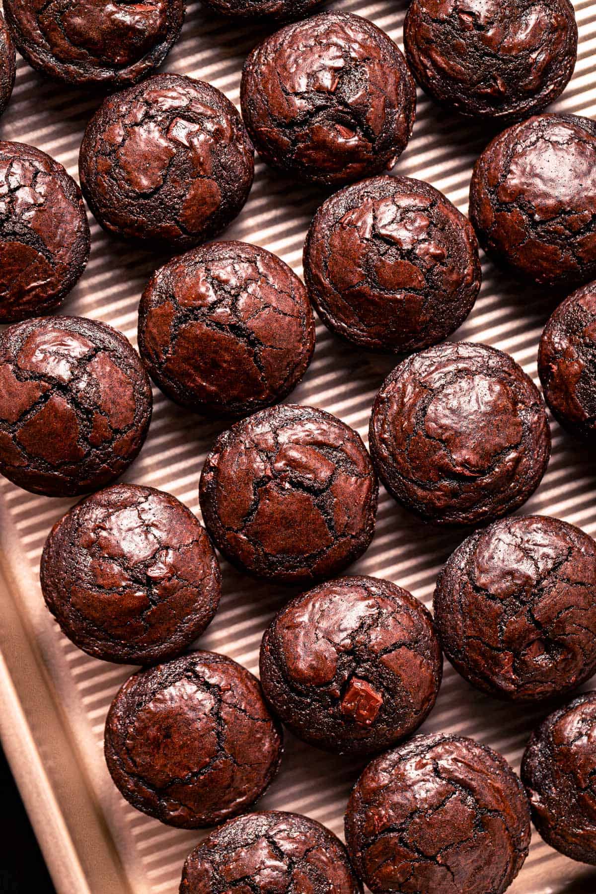 brownie bites lined up on baking tray.