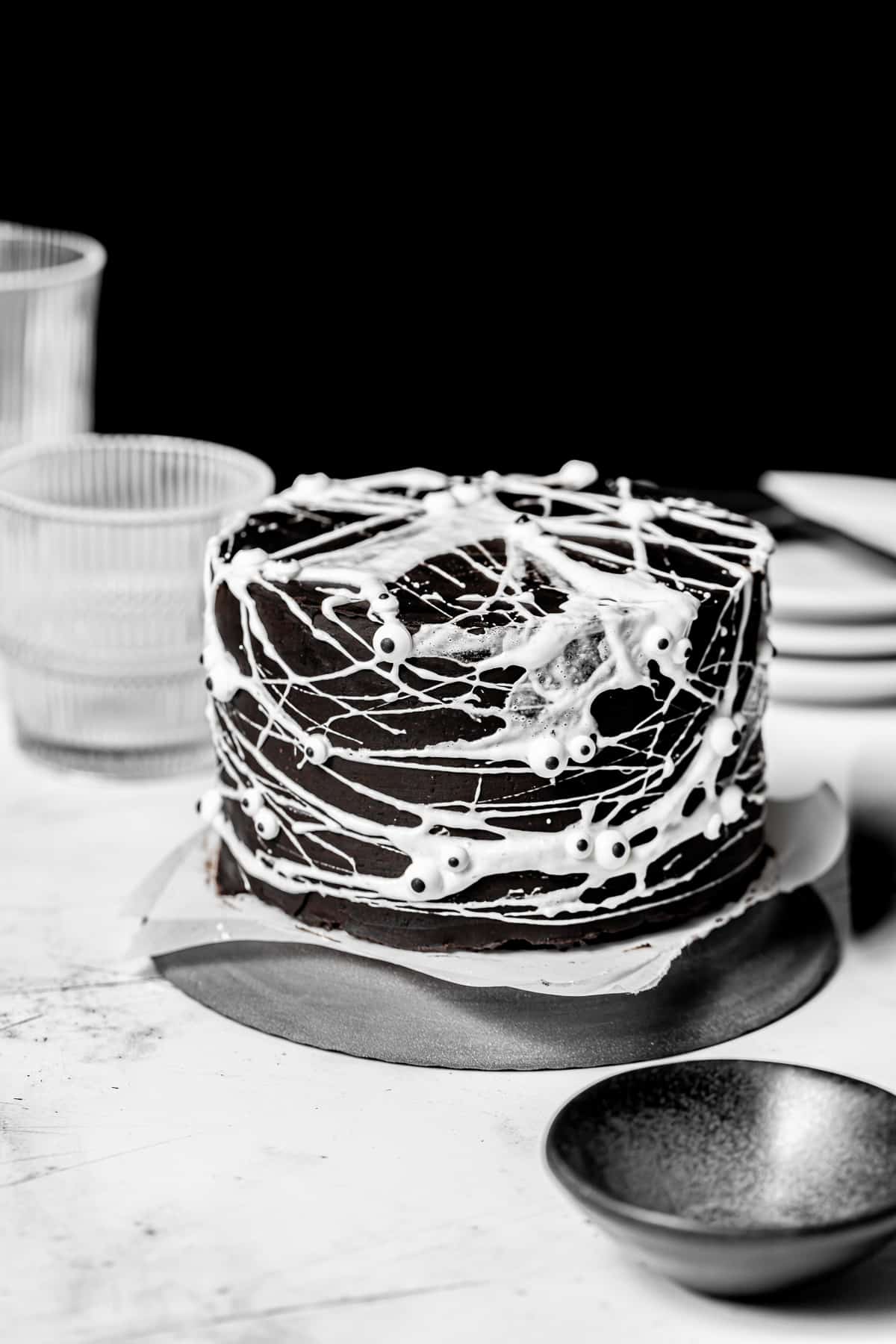 decorated spider web cake on plate.