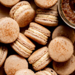 apple butter macarons in a pile.