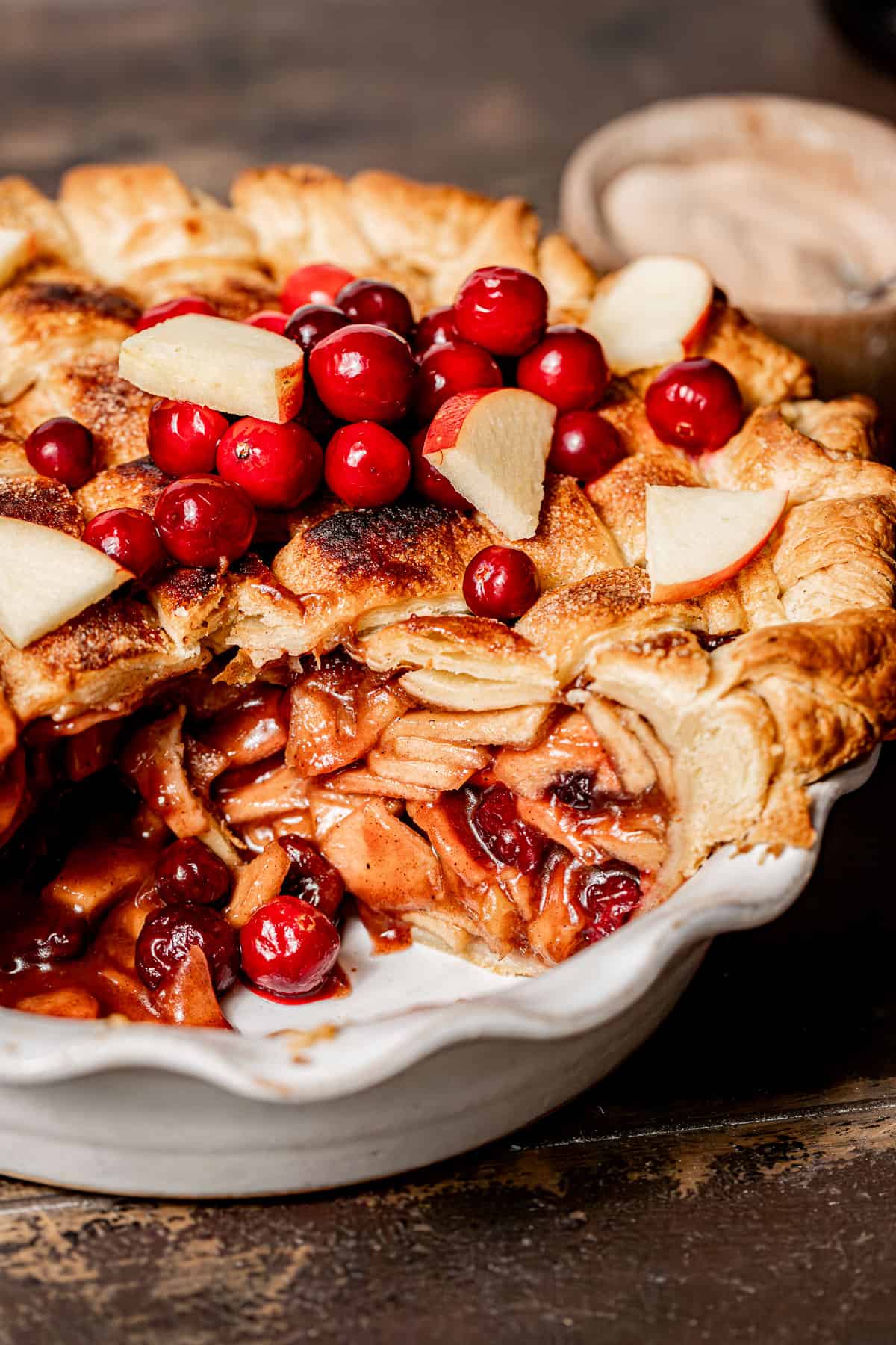 interior shot of apple cranberry pie in white pie dish.