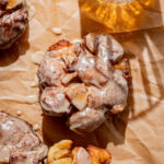 apple fritters on parchment paper.
