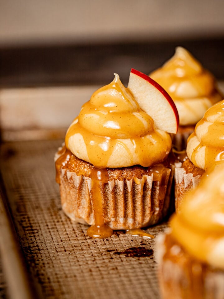 caramel apple cupcakes on baking sheet.