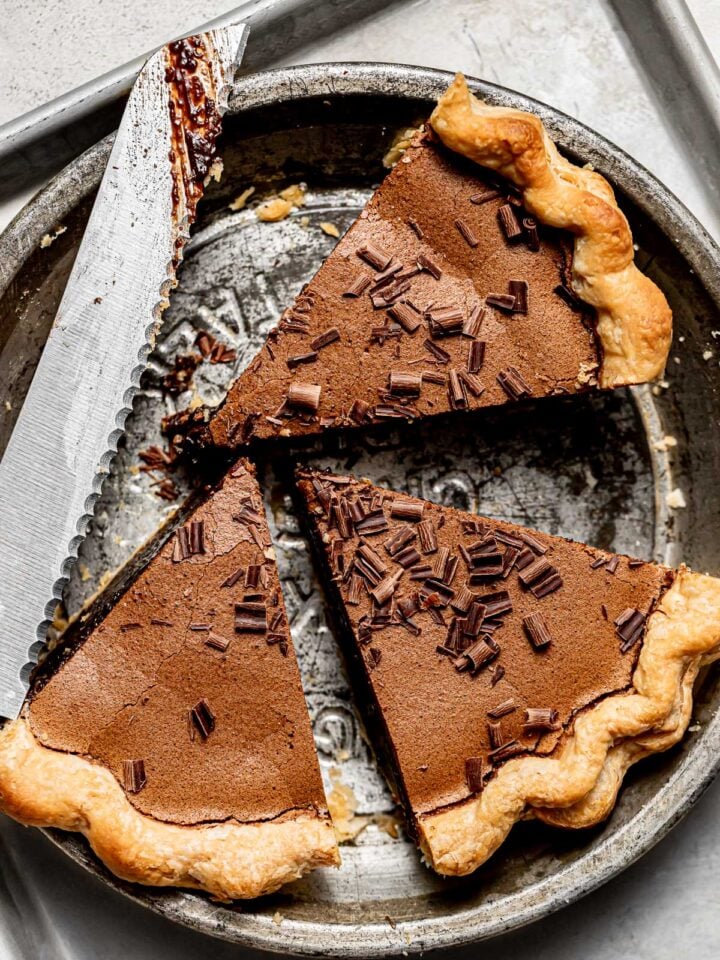 chocolate chess pie pieces in pie plate.