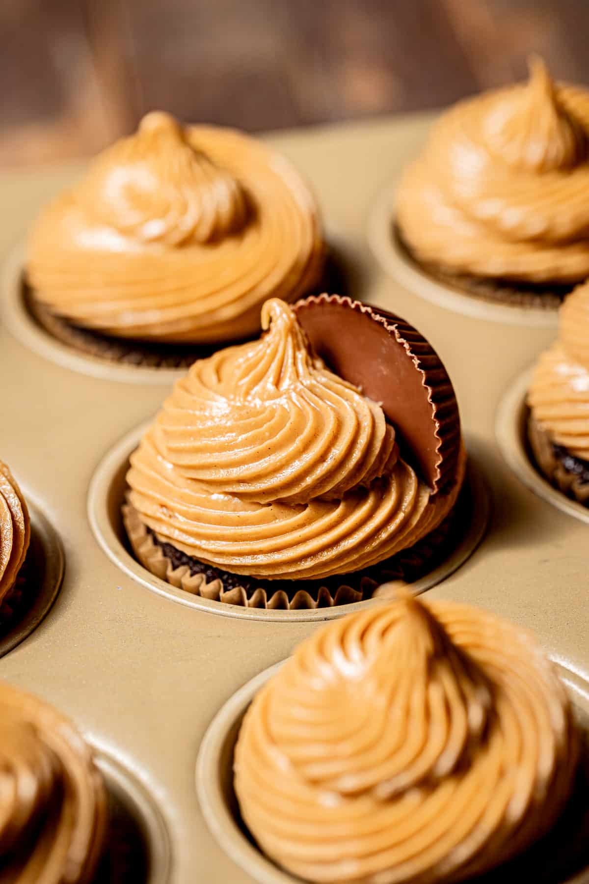 decorated chocolate peanut butter cupcakes in baking pan.