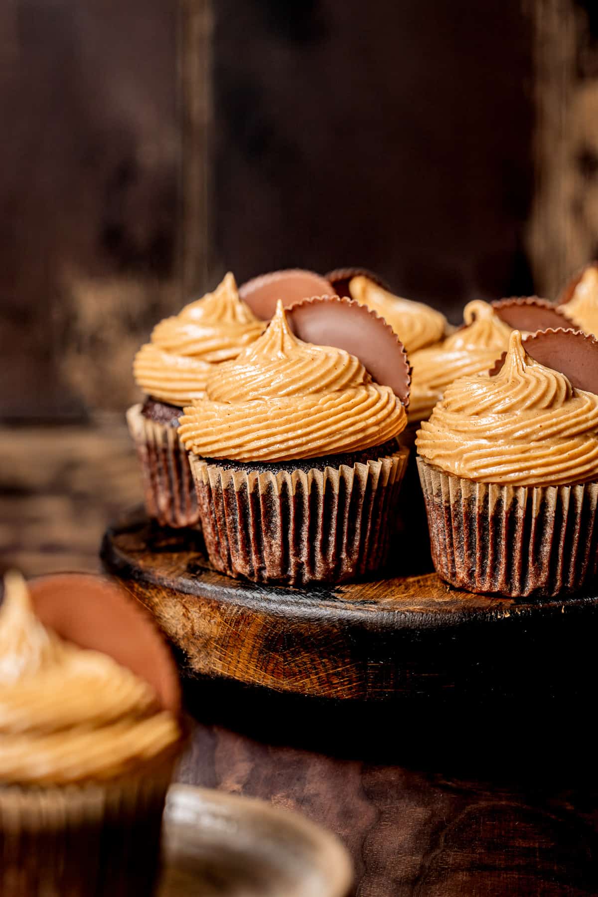chocolate peanut butter cup cupcakes on cake stand.