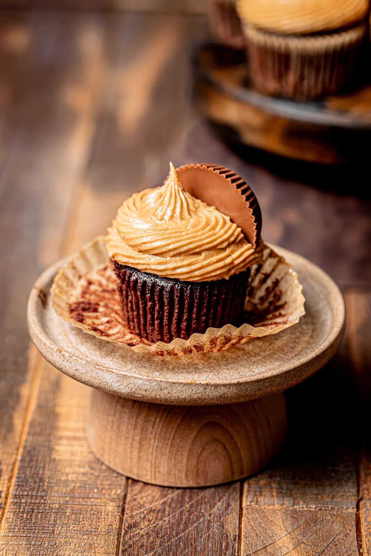 chocolate peanut butter cup cupcake on cake stand.