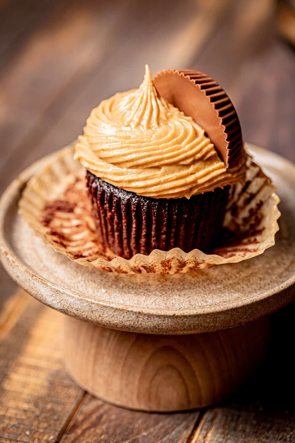 one chocolate peanut butter cup cupcake on a stand.