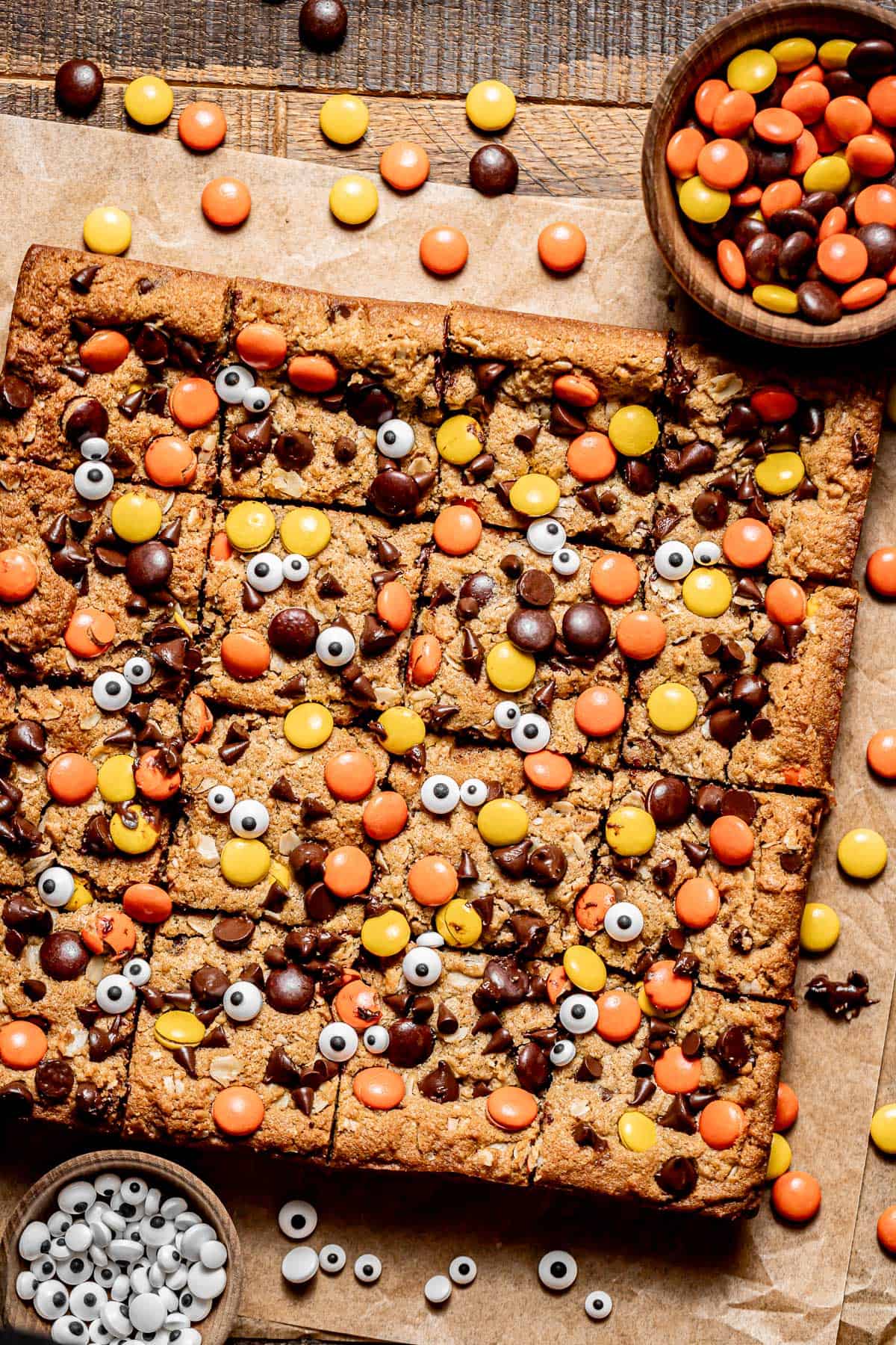 monster cookie bars on parchment paper.