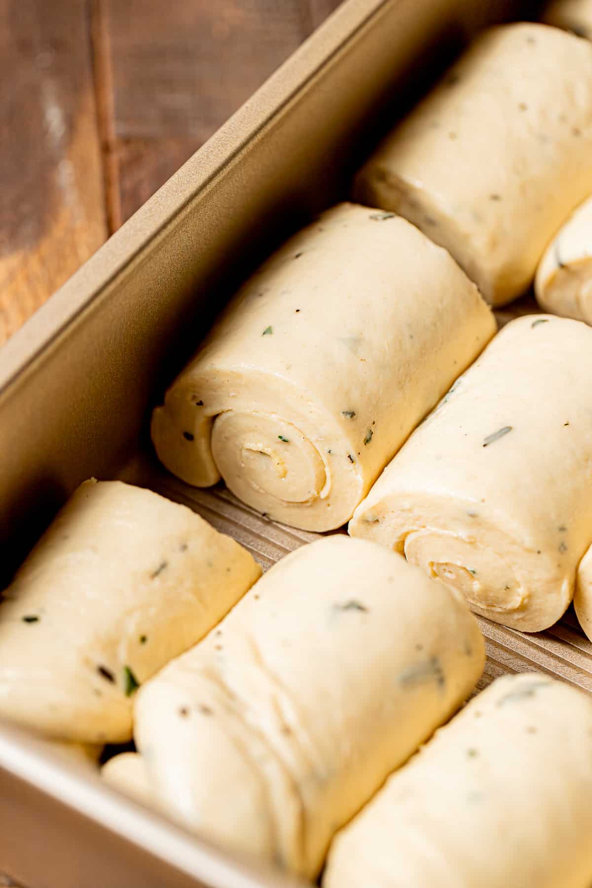 rolls of dough lined in baking pan.
