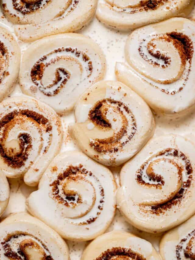 mini cinnamon rolls with heavy cream in round pan.