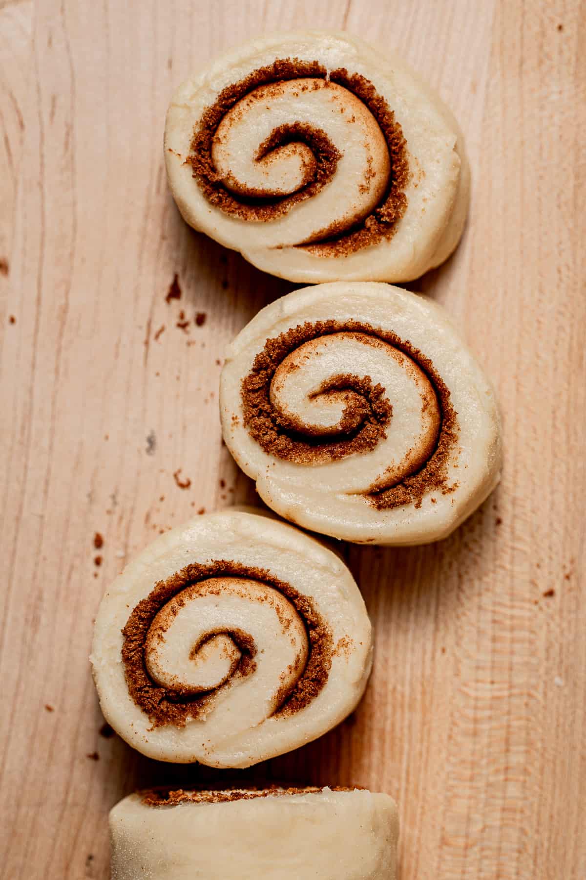 cinnamon rolls cut on cutting board. 
