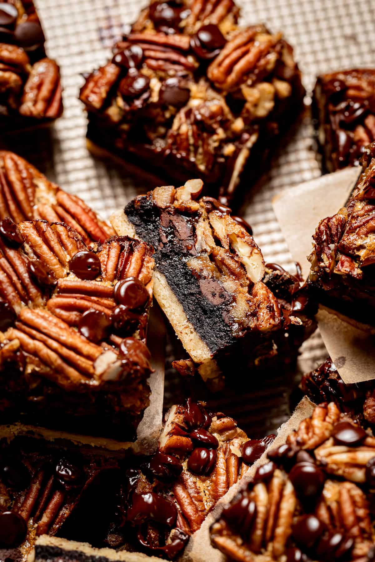 pecan pie brownies laying on baking sheet with one on its side.
