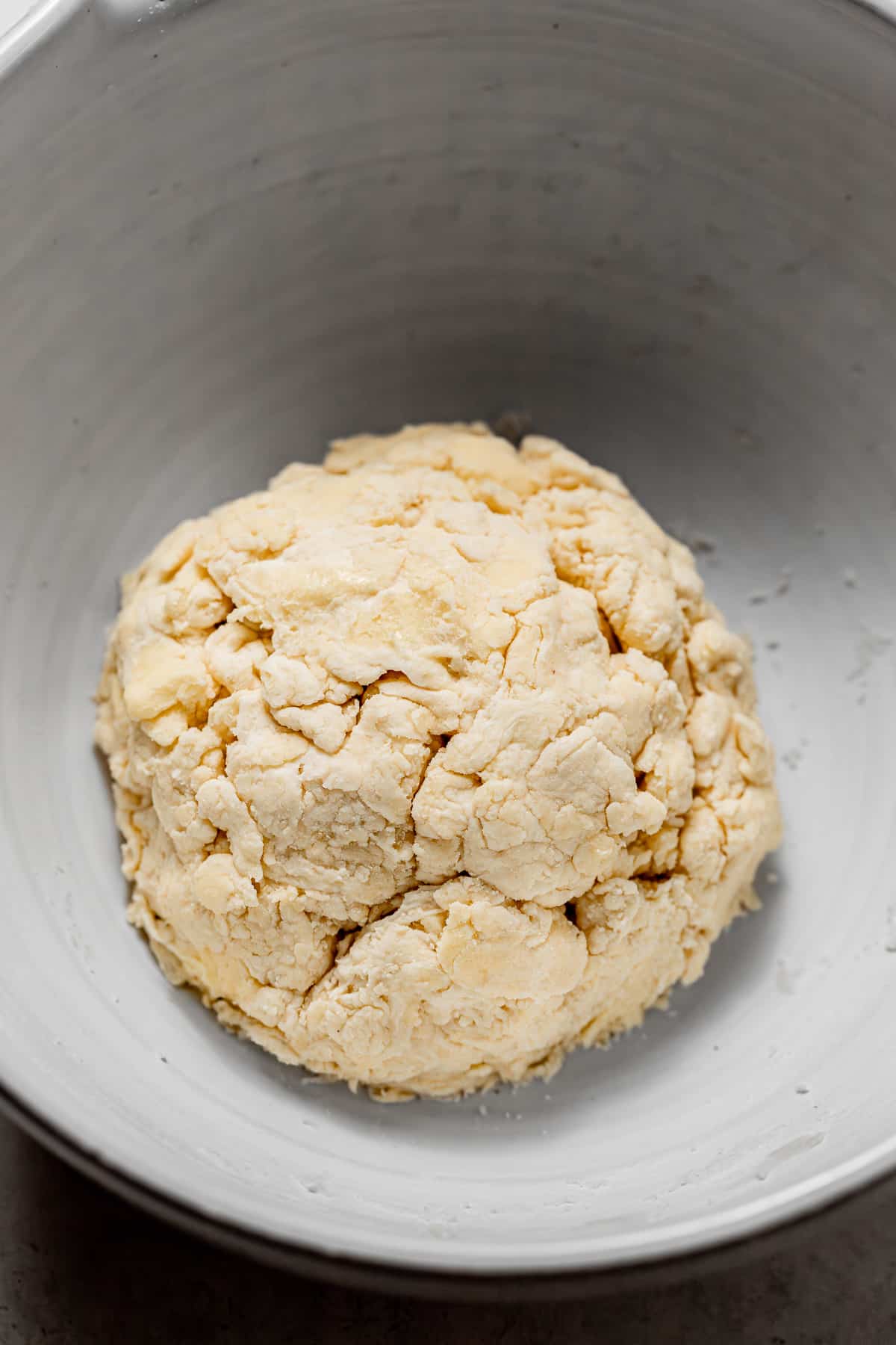 pie crust dough fully hydrated in bowl.