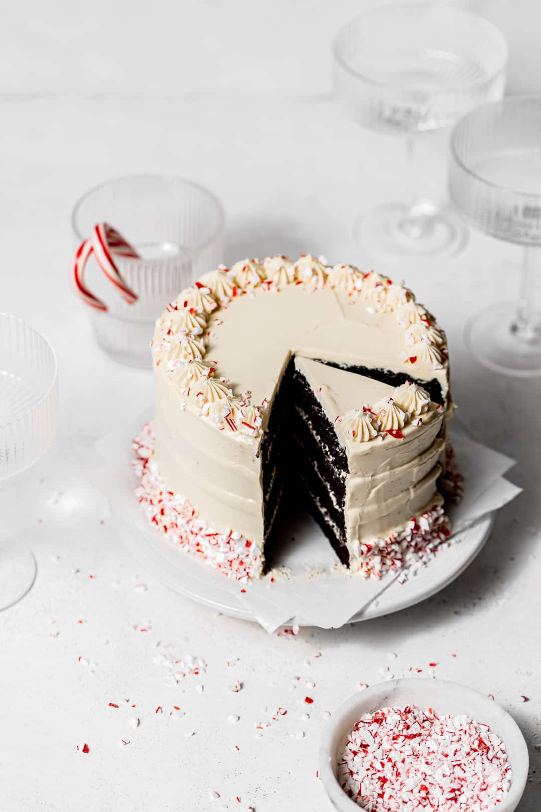 chocolate peppermint cake on white cake stand with slice taken out.