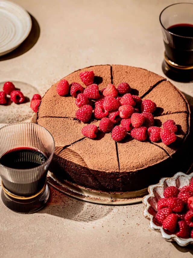 red wine chocolate cake with fresh raspberries on top.